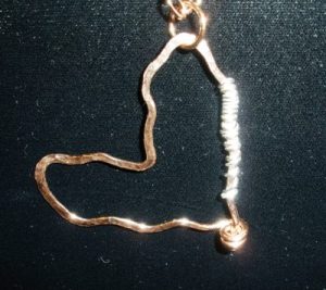 Hammered copper heart with sterling silver.