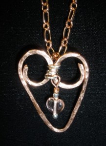 Hammered copper heart with fine silver and peach drop.
