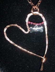 Copper heart with wrapped silver, garnet, charm.