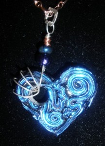 Dichroic glass heart with silver and copper.