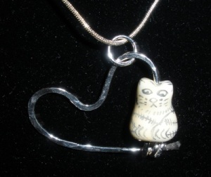 Ceramic kitty on silver heart pendant.
